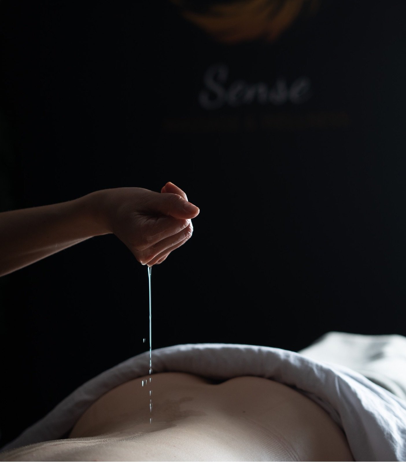Warm oil poured before a gentle rhythmic lymphatic massage